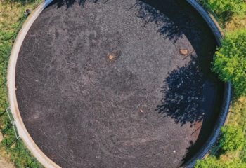 Vertical view down to a large circular tank for the storage of liquid manure